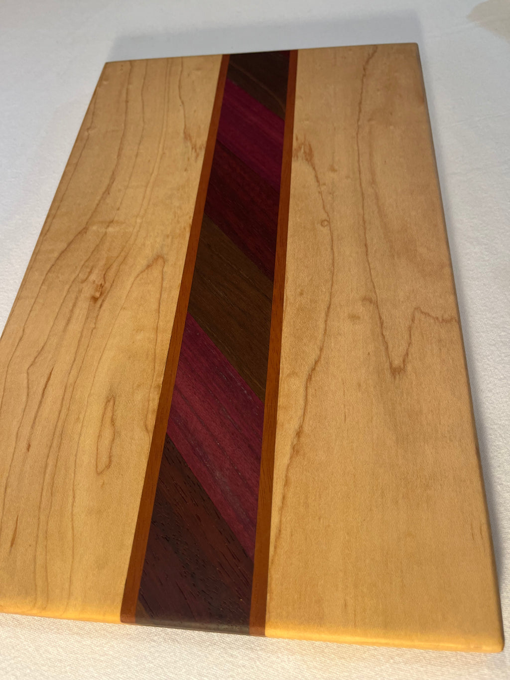 Maple cutting board with exotic inlay