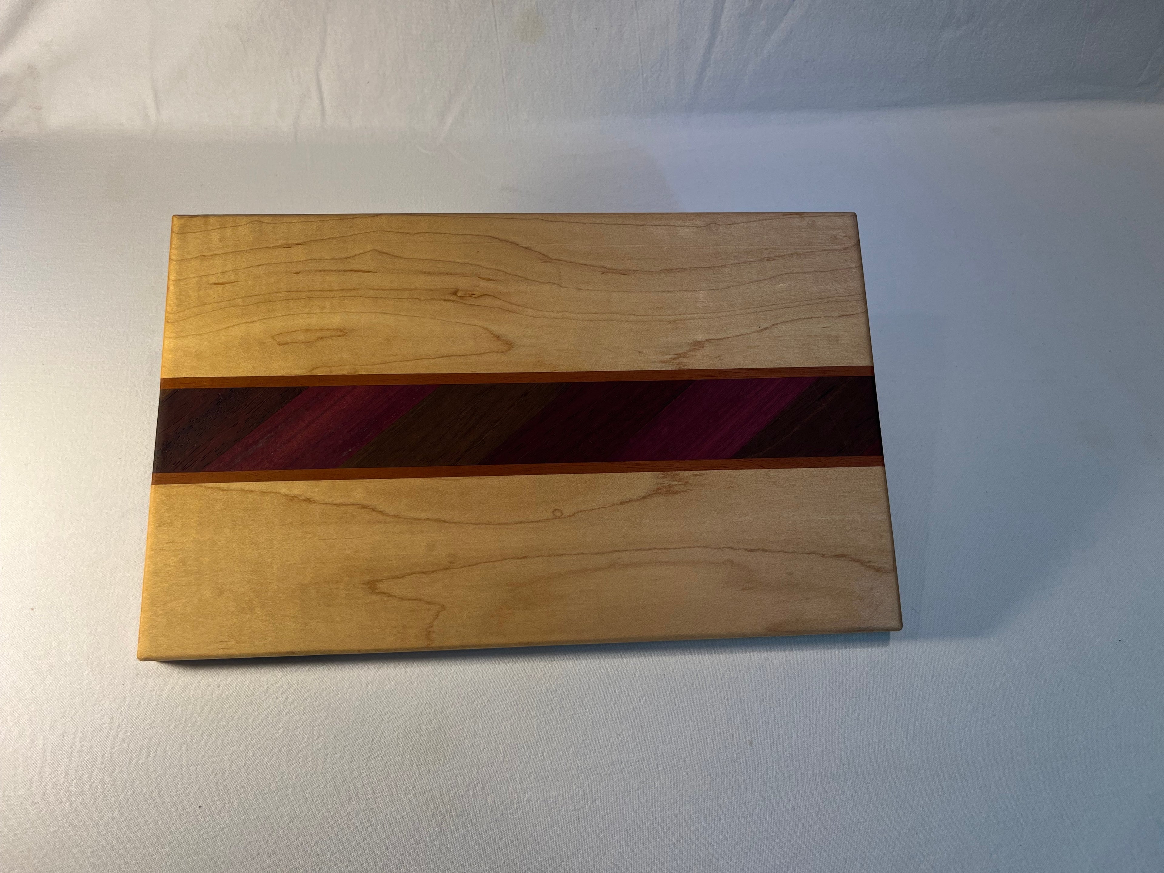 Maple cutting board with exotic inlay